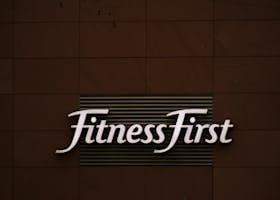 pexels-photo-1769735-1769735 Close-up of FitnessFirst gym sign on a contemporary brown wall.